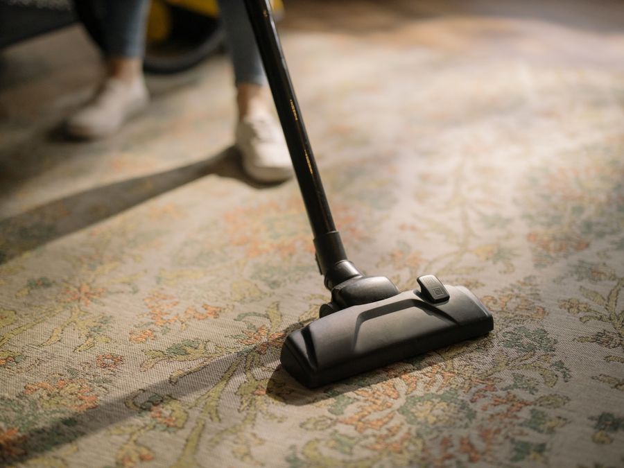 A vacuum cleaner being used on a patterned rug